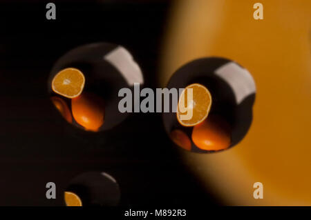 Oranges reflected in drops of water, juice Stock Photo