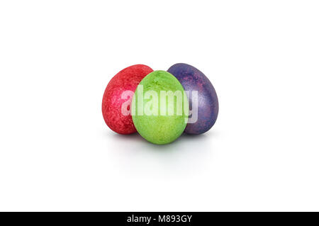 Three colorful handmade easter eggs isolated on a white. Red, green, purple egg painted with shiny paint. Decorative elements for Easter celebration Stock Photo