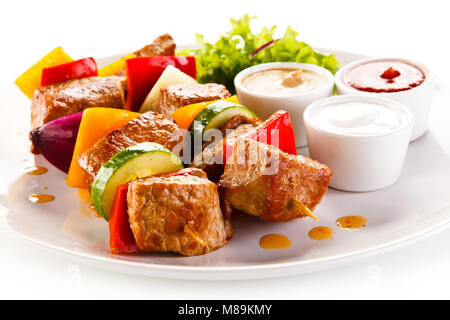 Grilled meat and vegetables on white background Stock Photo