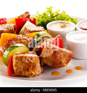 Grilled meat and vegetables on white background Stock Photo