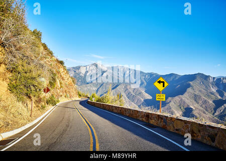 Sharp turn left sign in Yosemite National Park at sunset, California, USA. Stock Photo