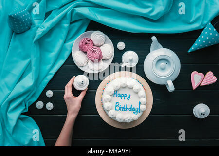 woman putting cupcake on birthday table Stock Photo