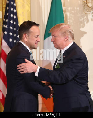 US President Donald Trump shakes hands with Irish Taoiseach Leo Varadkar (left) at the annual shamrock presentation ceremony at the White House in Washington DC, USA. Stock Photo