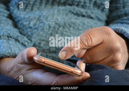 Senior man using a smartphone Stock Photo
