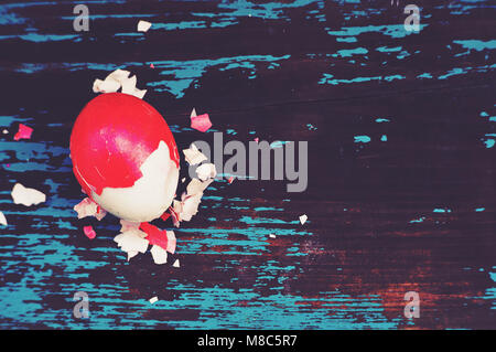 Colorful easter egg. Background with easter eggs. Red boiled egg in a red shell. Traditional Easter Breakfast in vintage style. eggshell, shell, hull Stock Photo