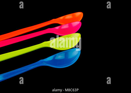 Plastic spoons on black background Stock Photo