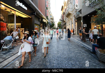 Ermou pedestrian street is always busy with shoppers and tourist. Stock Photo