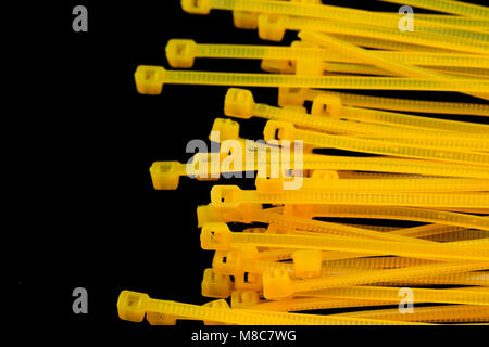 Yellow Nylon Cable Ties on black Background Stock Photo