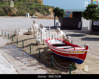 ALBUFEIRA, SOUTHERN ALGARVE/PORTUGAL - MARCH 10 : View of a Fishing Boat and People Statues at Albufeira in Portugal on March 10, 2018. Unidentified people Stock Photo