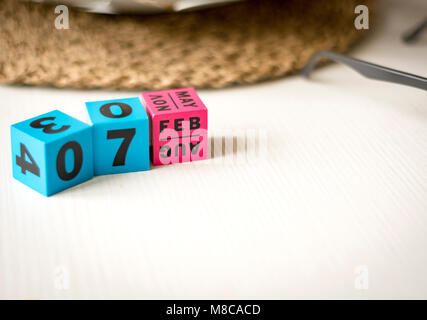 modern perpetual calendar composed of colored cubes and set at the date of February 7th Stock Photo