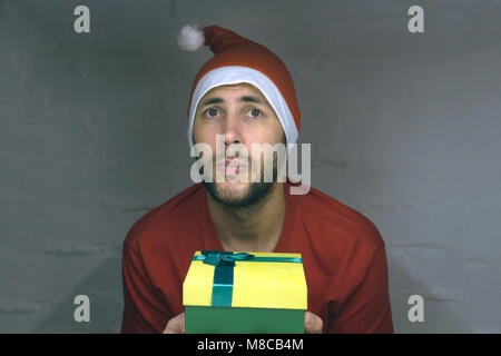 Santa Claus in authentic look confused about easter eggs. All on white background Stock Photo