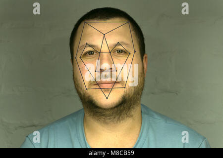Biometric verification - young man face recognition Stock Photo