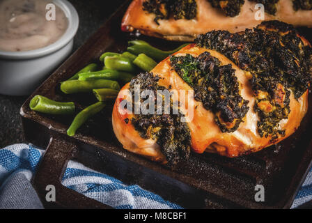Healthy dinner, Pollo a fisarmonica con ricotta e spinaci, chicken fillet baked with cheese and spinach. On grill pan, with sauce and fresh vegetables Stock Photo