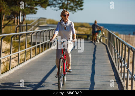 Woman riding bike outdoor Stock Photo