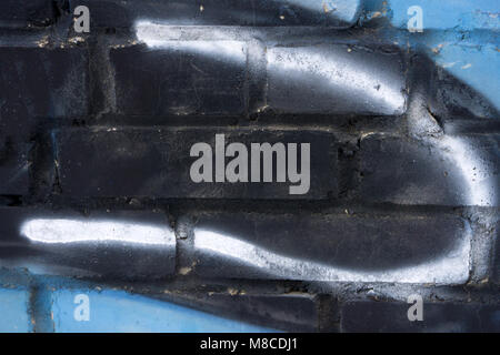 Texture of old brick wall painted blue and black, white stripe Stock Photo