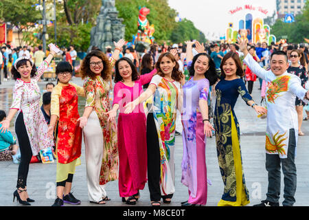 A group of Vietnamese ladies (and one man) dressed in traditional dress to celebrate the Chinese Lunar New Year, Ho Chi Minh City, Saigon, Vietnam