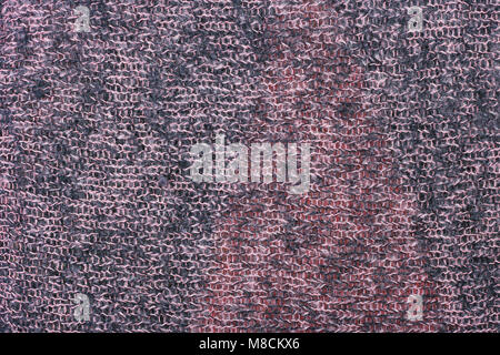 The handmade sweater is tied with thick pink and black color threads. The mass production  pattern resembles small knots Stock Photo