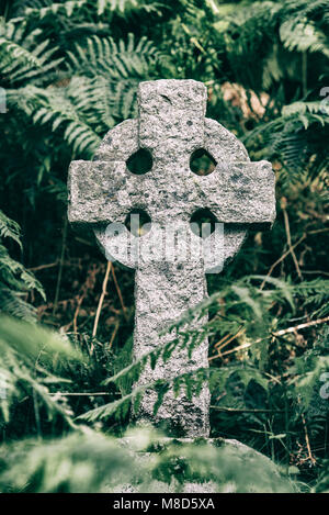 Celtic Cross as tombstone on grave in graveyard Stock Photo