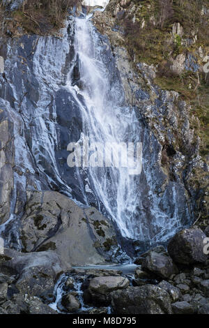 Aber Falls waterfall or Rhaeadr Fawr with frozen water on rocks in Coedydd Aber National Nature Reserve in Snowdonia. Abergwyngregyn Wales UK Stock Photo