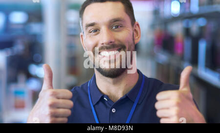 Portrait of a Professional Consultant Smiling and Giving Thumbs Up in the Bright, Modern Electronics Store.The Depth of Field Shot.