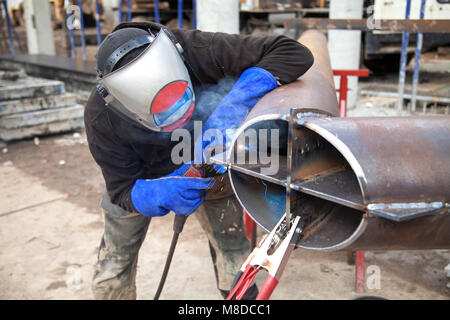 Welding work, welder welding metal material in heavy industry manufacturing, video clip