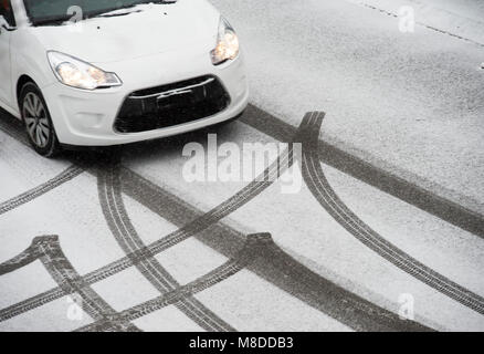 Skidmarks from a car in the fresh snow on a road Stock Photo