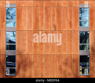 Rusty steel panels and windows on a modern building. Stock Photo
