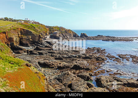 Looking back towards the old lifeboat station in Polpeor Cove, Lizard Point on the Lizard Peninsula, Cornwall, South West England, UK Stock Photo