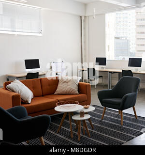 Square image of modern office space with tables and chairs, computers and office supplies with no employees Stock Photo