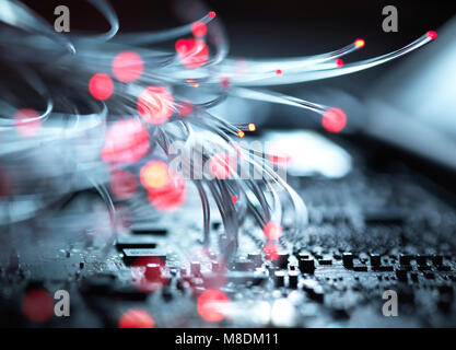 Fibre optics carrying data passing the inside circuit boards of a laptop computer Stock Photo