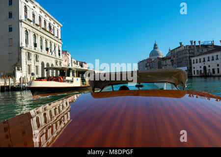 Old Buildings and a Ferry Along the Shoreline of the Grand Canal Viewed From a Boat in Venice, Veneto, Italy Stock Photo