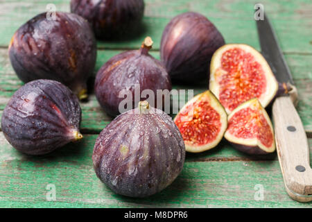 Fresh ripe organic figs with drops of water on a wooden table. Selective focus Stock Photo