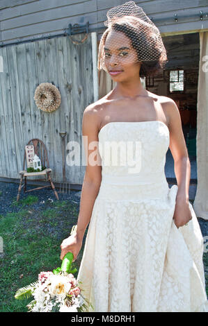 Portrait of bride wearing wedding dress, and veil, outdoors Stock Photo