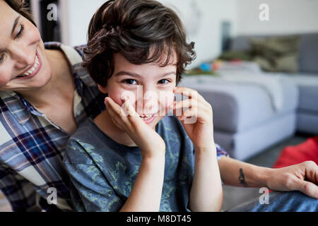 Mother and son at home, smiling Stock Photo