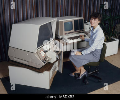 Woman using a 3M computerised microfilm reader - 1980's Stock Photo