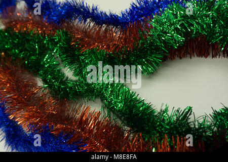 Christmas toys golden and red color in tinsel, blue, silver and green colors close up , Stock Photo