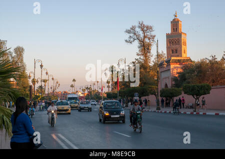 Late afternoon traffic along Avenue Mohammed V with the minaret of Koutoubia Mosque in the background in Marrakesh, Morocco. Stock Photo