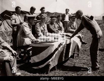 1943 Middle East Syria - scene at Aleppo - British army recruits - recruit taking oath on the Koran Stock Photo