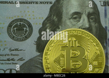 golden bitcoin coin on us dollars close up , Stock Photo