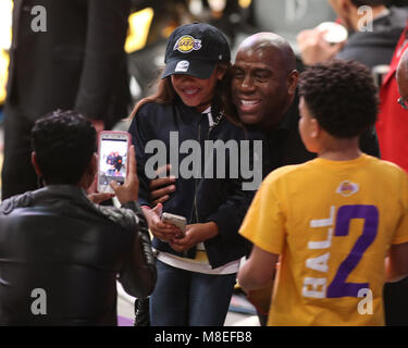 Los Angeles, CA, USA. 11th Mar, 2018. Los Angeles Lakers Magic Johnson taking time for photo for young fan during the 4th quarter of Cleveland Cavaliers vs Los Angeles Lakers at Staples Center on March 11, 2018. (Photo by Jevone Moore) Credit: csm/Alamy Live News Stock Photo