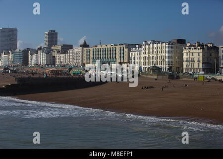 Brighton,UK,16th March 2018,People enjoy the warm and sunny weather and sit on the beach at Brighton.credit Keith Larby/Alamy Live News Stock Photo