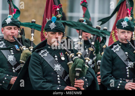 London, UK, 17 Mar 2018. The pipes march on - The Duke of Cambridge, Colonel of the Irish Guards, accompanied by The Duchess of Cambridge, visited the 1st Battalion Irish Guards at their St. Patrick's Day Parade. 350 soldiers marched onto the Parade Square at Cavalry Barracks led by their mascot, the Irish Wolfhound Domhnall. Stock Photo