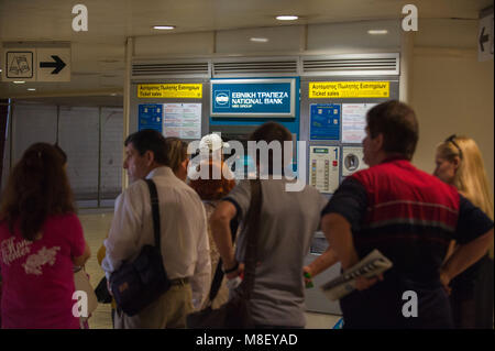 Athens. Greek people line up to withdraw mooney in a National Bank cash dispenser, Omonia tube station. Greece. Stock Photo