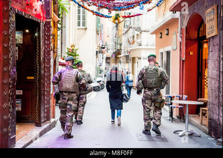 Armed soldiers walk through the old town district of Nice, France offering protection to locals and tourists in light of increased terrorist threats. Stock Photo
