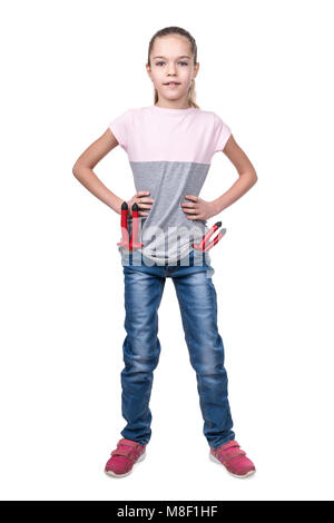 Portrait of a young girl in jeans with tools in pockets isolated on white background Stock Photo