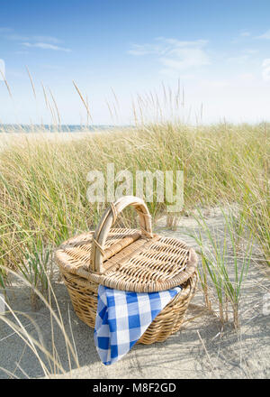Picnic basket on beach Stock Photo