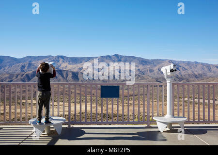 USA, Arizona, Boy (6-7) looking through coin operated binoculars Stock Photo