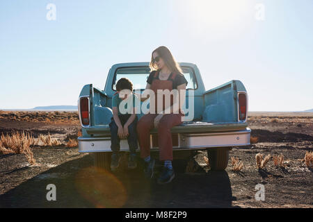 USA, Arizona, Mother comforting son (6-7) on tailgate of pick-up truck Stock Photo