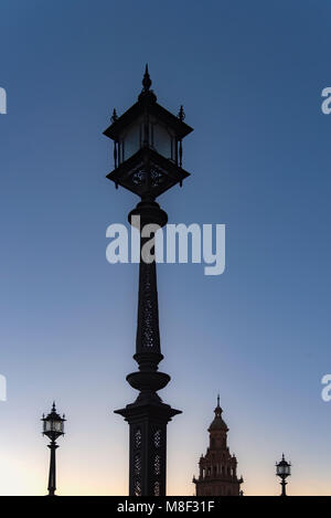 Spain, Andalusia, Seville, Plaza de Espana, Old fashioned street lights against clear sky at dawn Stock Photo