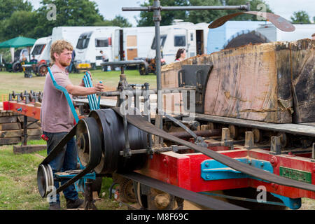 A demonstration of a saw bench driven by a traction engine at the 2017 Norton Fitzwarren Steam Rally, Somerset, England, UK Stock Photo